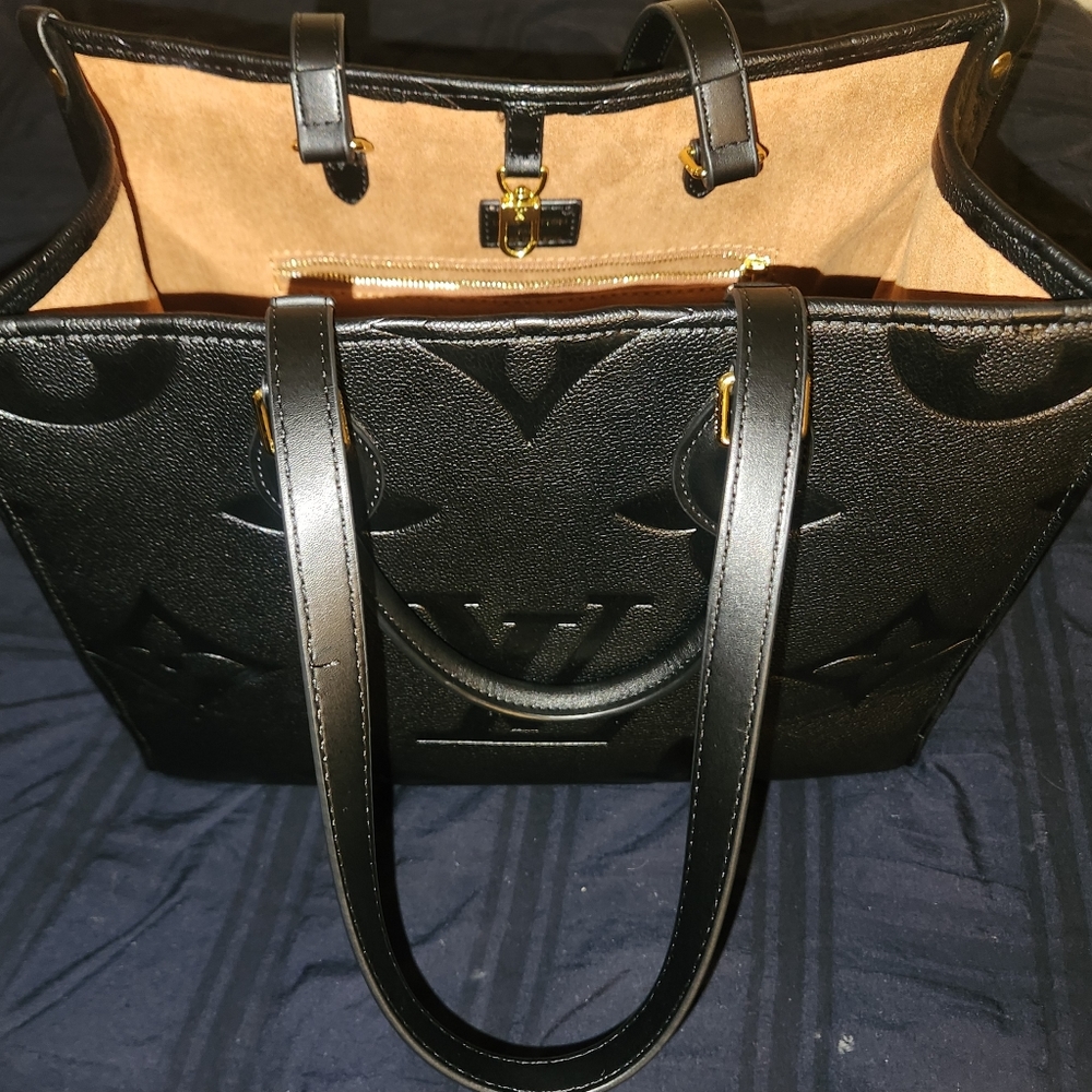 New black Louis Vuitton on the go Bag 2400 retail is 3440
